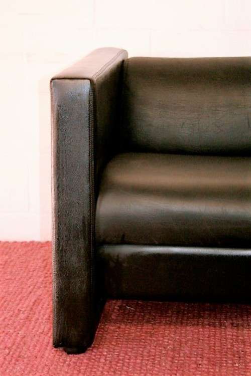 An awesome and stylish black bonded leather 2-seater "Tuxedo" couch in great condition