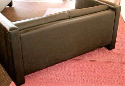An awesome and stylish black bonded leather 2-seater "Tuxedo" couch in great condition