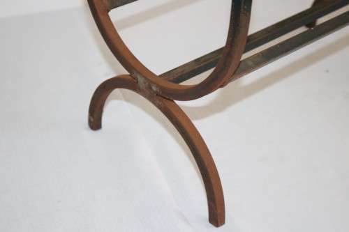 An awesome and well made wrought iron fireplace log holder with stunning "arrow" finials