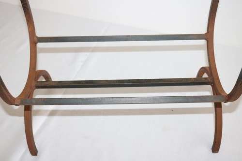 An awesome and well made wrought iron fireplace log holder with stunning "arrow" finials