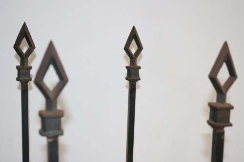 An awesome and well made wrought iron fireplace log holder with stunning "arrow" finials