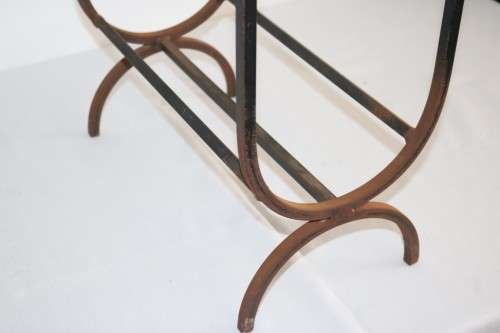 An awesome and well made wrought iron fireplace log holder with stunning "arrow" finials