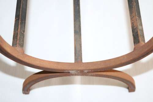 An awesome and well made wrought iron fireplace log holder with stunning "arrow" finials