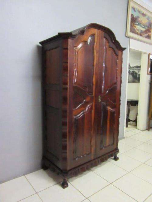 An amazing gabled double-door solid Imbuia ball & claw wardrobe w/ solid brass embellishments