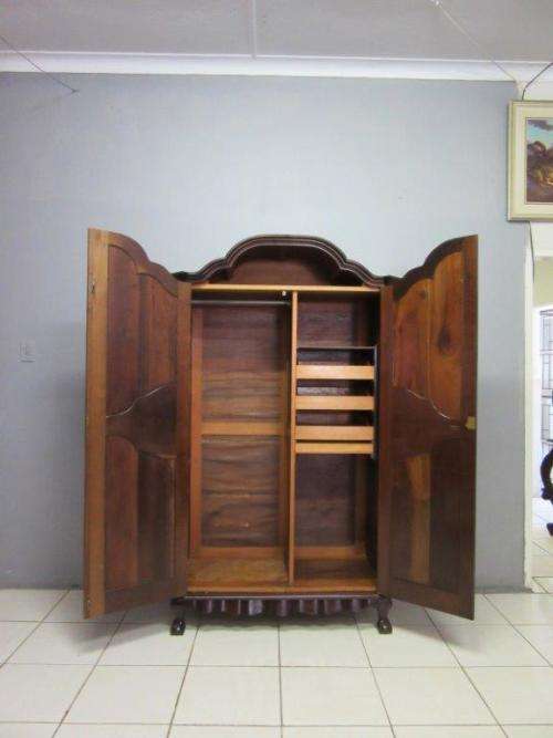 An amazing gabled double-door solid Imbuia ball & claw wardrobe w/ solid brass embellishments