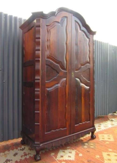An amazing gabled double-door solid Imbuia ball & claw wardrobe w/ solid brass embellishments