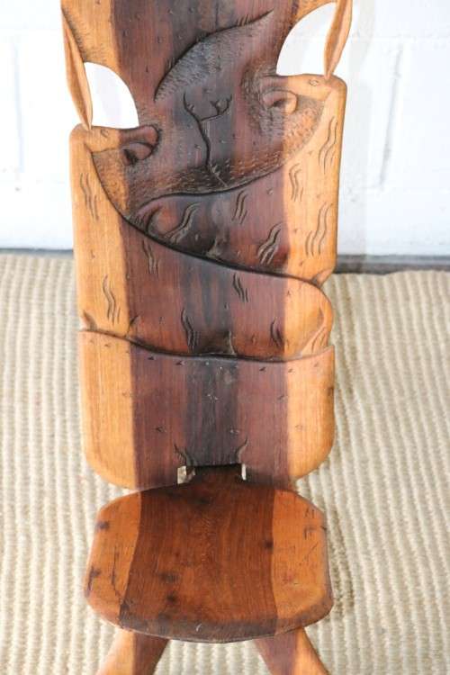 An amazing Blackwood African "birthing" chair with stunning hand carved detailing - practical!