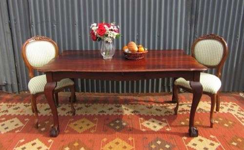 An amazing vintage Imbuia dining table with oversized ball and claw feet in wonderful condition