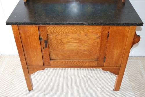 A wonderful vintage solid Oak wash stand with a black marble top and tiled splash back - stunning!