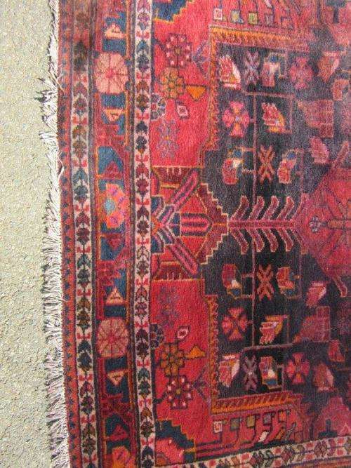 A wonderful vintage Persian Carpet (2.3m x 1.4m) in deep red, black and rust colours - stunning!