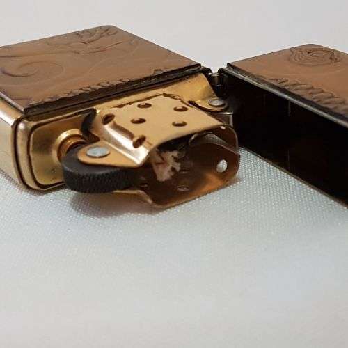 A collectable c1993 Zippo Barrett Smythe limited edition "Dinosaurs" T-Rex brass-finished lighter