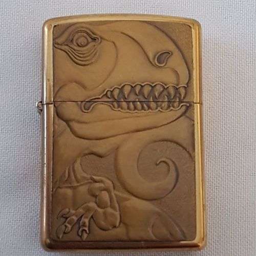 A collectable c1993 Zippo Barrett Smythe limited edition "Dinosaurs" T-Rex brass-finished lighter