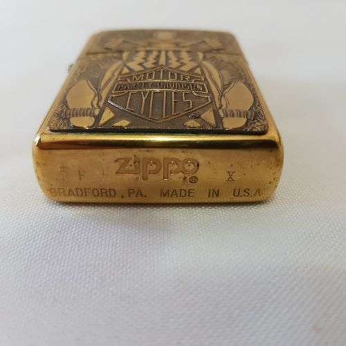 An incredible RARE unused brass Barrett Smythe "Harley Davidson" Tire (tyre) logo Zippo lighter