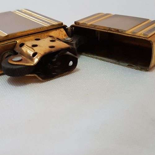 A stunning gold and silver detailed retro style authentic Zippo lighter in its original box