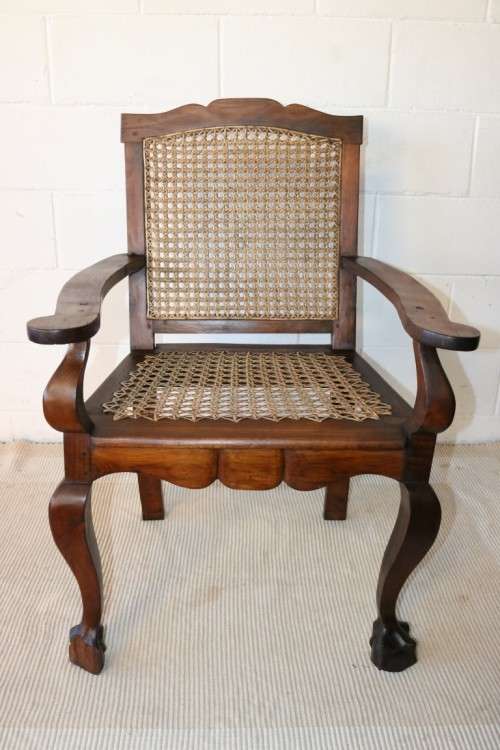A lovely rattan-back and seat arm chair with ball and claw feet & cabriole legs - great for a patio!