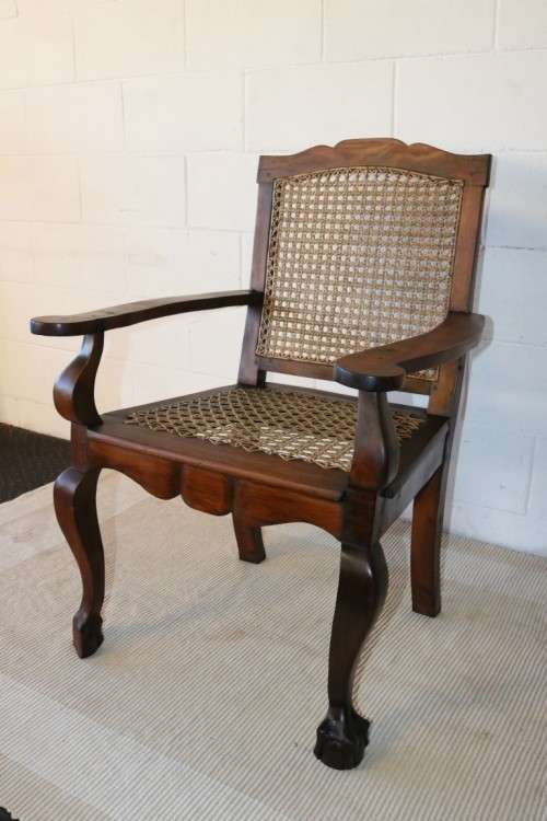 A lovely rattan-back and seat arm chair with ball and claw feet & cabriole legs - great for a patio!