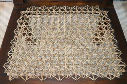 A lovely rattan-back and seat arm chair with ball and claw feet & cabriole legs - great for a patio!