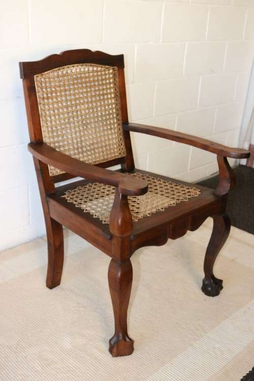 A lovely rattan-back and seat arm chair with ball and claw feet & cabriole legs - great for a patio!