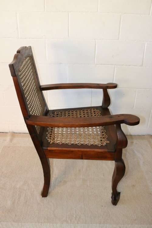 A lovely rattan-back and seat arm chair with ball and claw feet & cabriole legs - great for a patio!