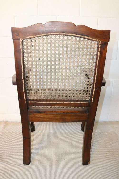 A lovely rattan-back and seat arm chair with ball and claw feet & cabriole legs - great for a patio!