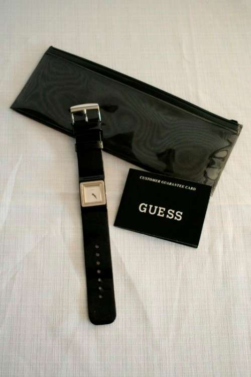 A fabulous original Guess ladies quartz wrist watch in its original pouch w/ purchase guarantee card