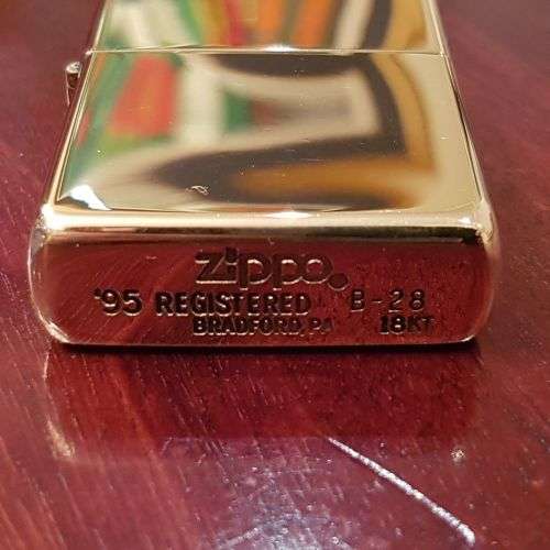 A superbly rare one-of-a-kind limited edition 18ct solid gold Zippo lighter in its custom walnut box