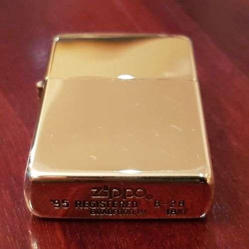 A superbly rare one-of-a-kind limited edition 18ct solid gold Zippo lighter in its custom walnut box
