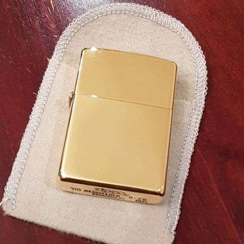 A superbly rare one-of-a-kind limited edition 18ct solid gold Zippo lighter in its custom walnut box
