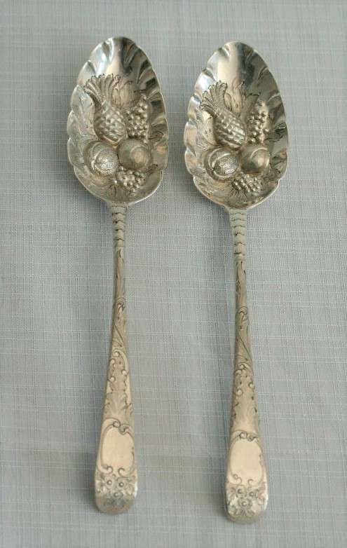 A spectacularly rare ornate pair of antique Victorian hallmarked Theodor Cohn sterling silver spoons