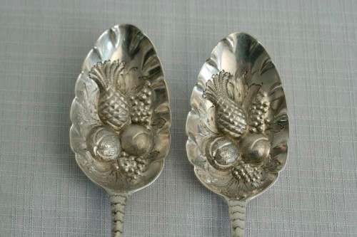 A spectacularly rare ornate pair of antique Victorian hallmarked Theodor Cohn sterling silver spoons