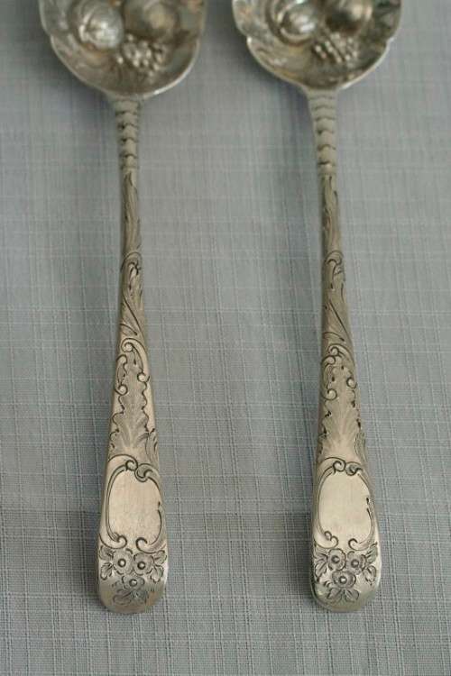 A spectacularly rare ornate pair of antique Victorian hallmarked Theodor Cohn sterling silver spoons