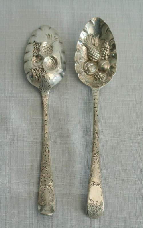 A spectacularly rare ornate pair of antique Victorian hallmarked Theodor Cohn sterling silver spoons