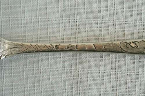 A spectacularly rare ornate pair of antique Victorian hallmarked Theodor Cohn sterling silver spoons