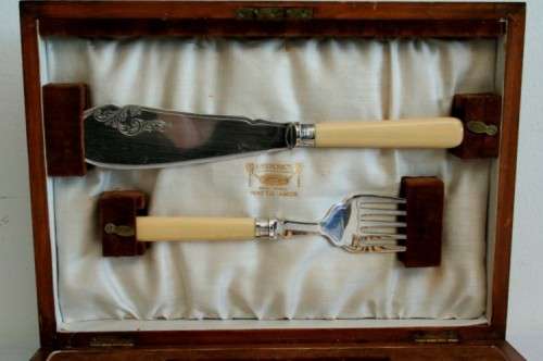 A superb vintage sterling silver cuff bone handle fish knife and fork set in its wooden canteen