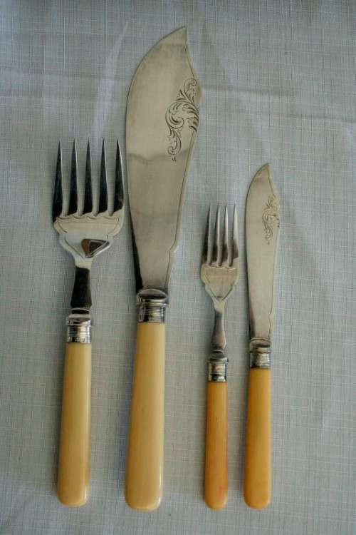 A superb vintage sterling silver cuff bone handle fish knife and fork set in its wooden canteen