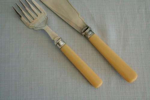 A superb vintage sterling silver cuff bone handle fish knife and fork set in its wooden canteen