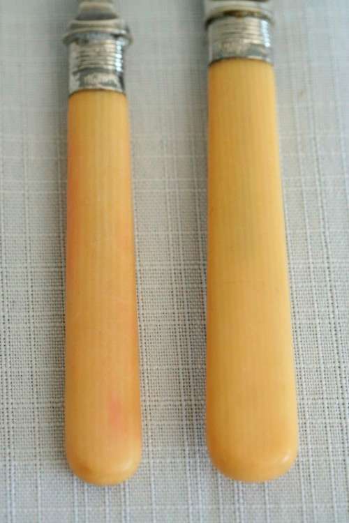 A superb vintage sterling silver cuff bone handle fish knife and fork set in its wooden canteen