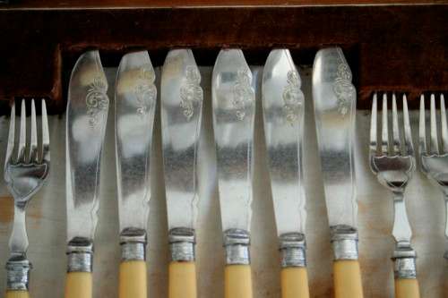 A superb vintage sterling silver cuff bone handle fish knife and fork set in its wooden canteen