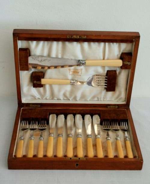 A superb vintage sterling silver cuff bone handle fish knife and fork set in its wooden canteen