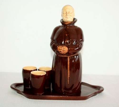 An awesome vintage Beswick Heatmaster Monk decanter with three cups on a porcelain serving plate