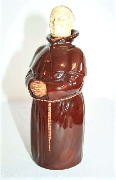 An awesome vintage Beswick Heatmaster Monk decanter with three cups on a porcelain serving plate