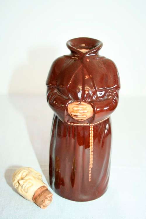 An awesome vintage Beswick Heatmaster Monk decanter with three cups on a porcelain serving plate