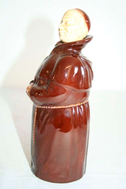 An awesome vintage Beswick Heatmaster Monk decanter with three cups on a porcelain serving plate