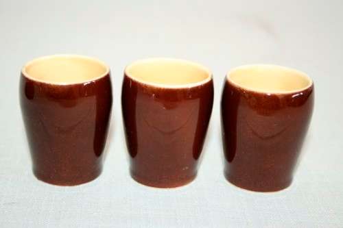 An awesome vintage Beswick Heatmaster Monk decanter with three cups on a porcelain serving plate