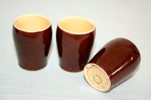 An awesome vintage Beswick Heatmaster Monk decanter with three cups on a porcelain serving plate