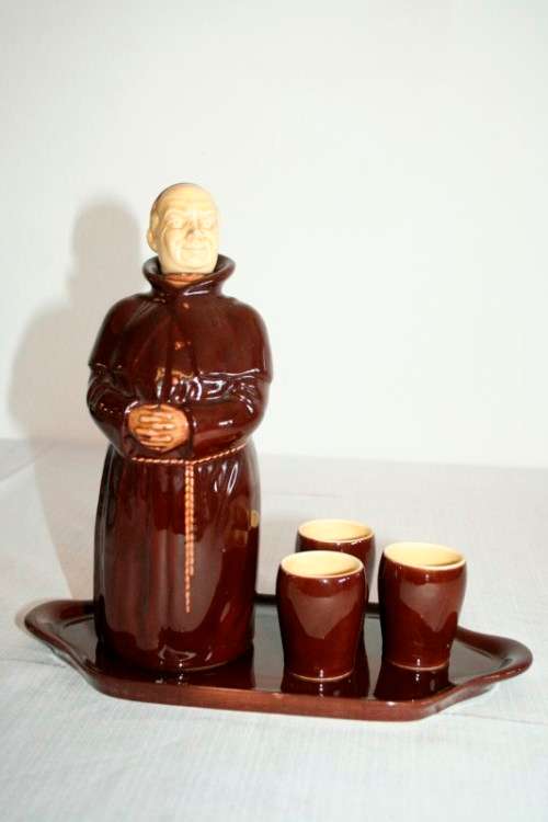 An awesome vintage Beswick Heatmaster Monk decanter with three cups on a porcelain serving plate