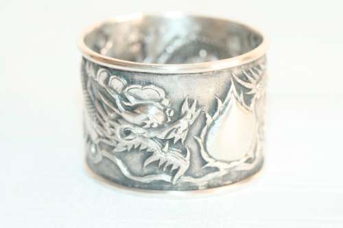 An incredible and rare Chinese solid silver "Dragon" napkin ring with amazing hand chased detailing