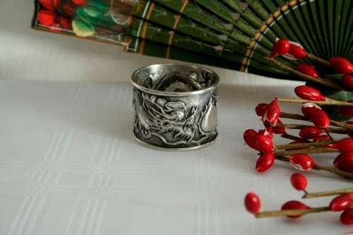 An incredible and rare Chinese solid silver "Dragon" napkin ring with amazing hand chased detailing