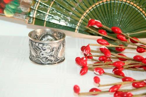 An incredible and rare Chinese solid silver "Dragon" napkin ring with amazing hand chased detailing