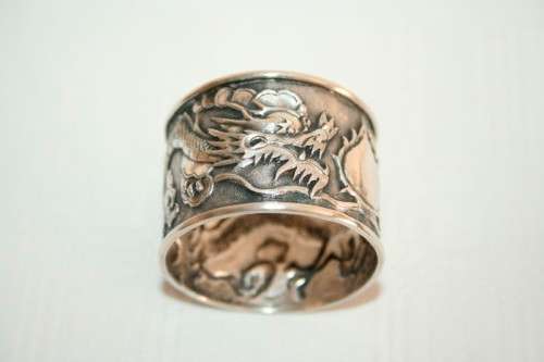 An incredible and rare Chinese solid silver "Dragon" napkin ring with amazing hand chased detailing